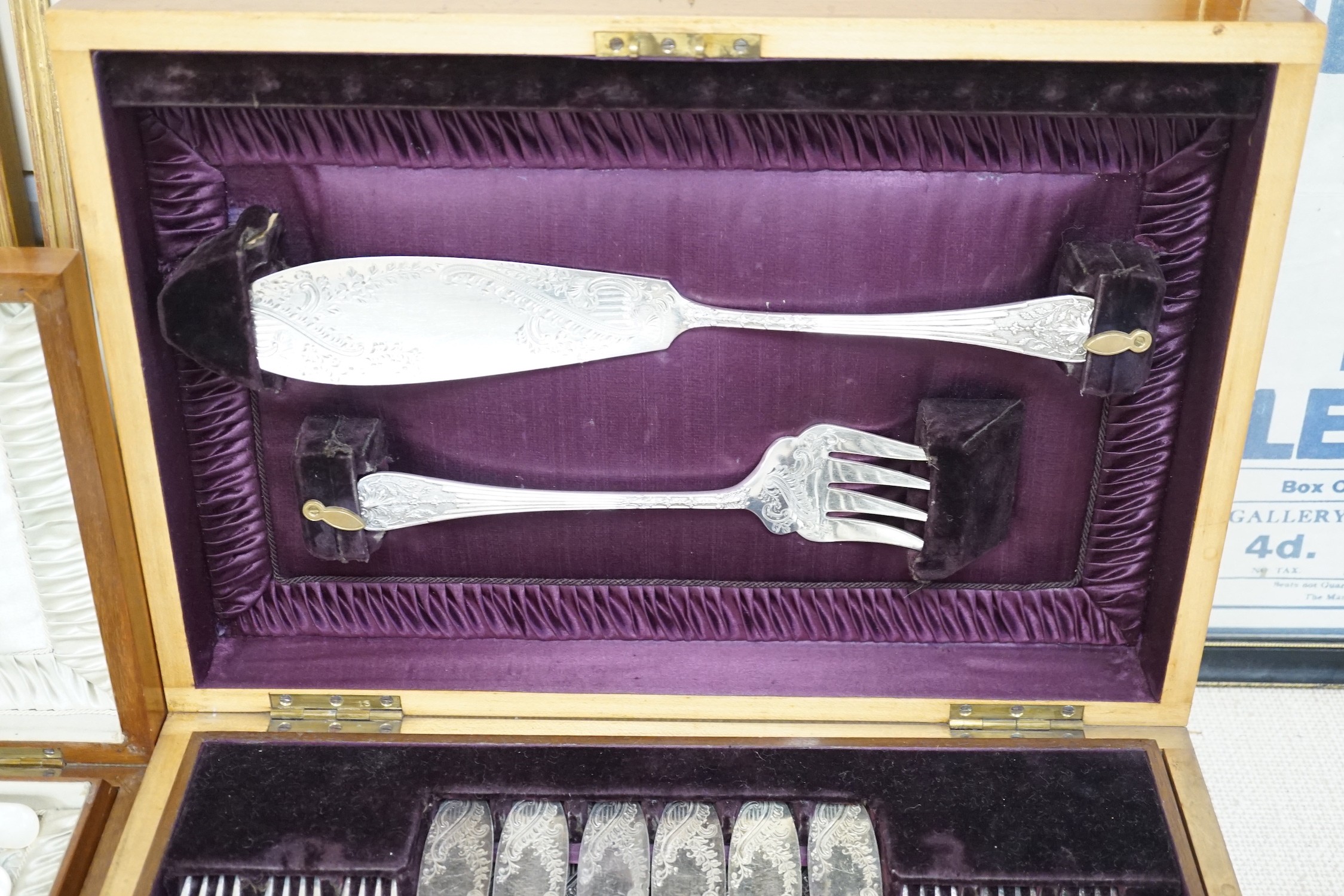 Two cased electroplate sets: a set of twelve fruit eaters and twelve fish knives and forks
